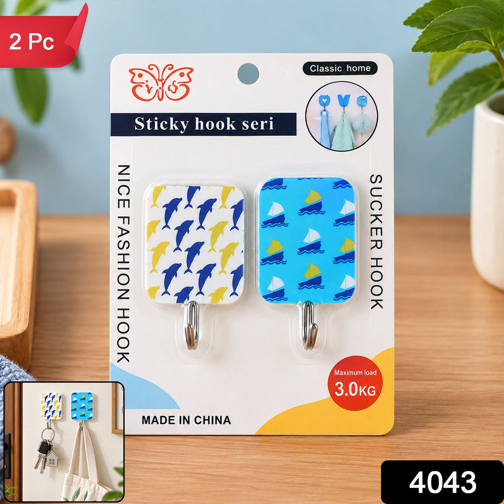 Packaged adhesive hooks with dolphin and sailboat patterns, featuring a small inset image of them in use.