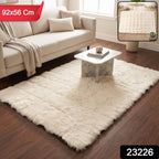 A cream fluffy faux fur rug on a wooden floor, with a red banner indicating 92x56 cm dimensions.